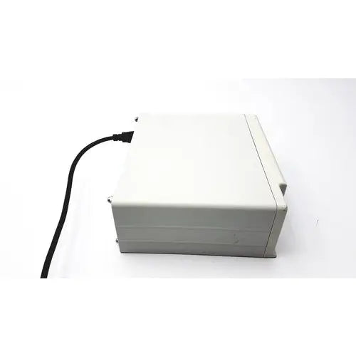 A beige plastic cash register with a black power cord for masimo surgical extraction pulse oximeter use