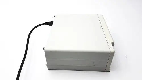 A beige plastic cash register with a black power cord for masimo surgical extraction pulse oximeter use