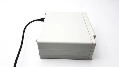 A beige plastic cash register with a black power cord for masimo surgical extraction pulse oximeter use