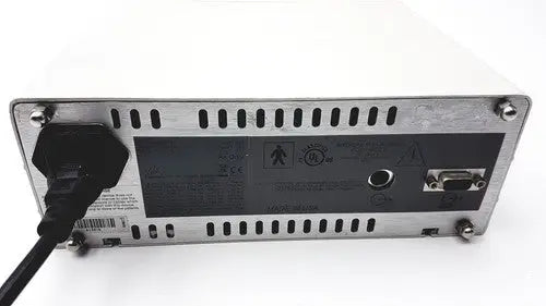 Silver metallic masimo surgical extraction pulse oximeter rear panel with black power cord and certification labels