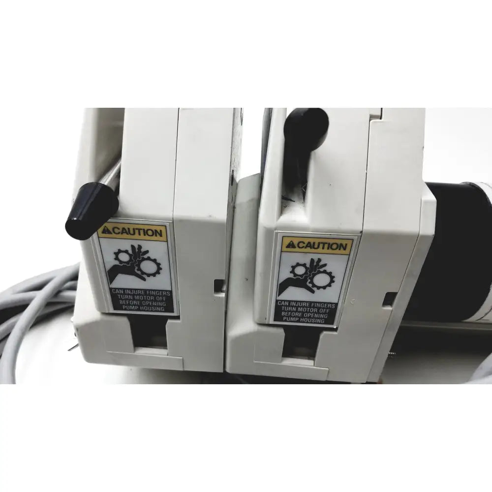White industrial pump units with black handles and caution labels for masterflex ip digital modular drive modular drive