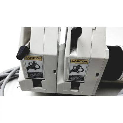 White industrial pump units with black handles and caution labels for masterflex ip digital modular drive modular drive
