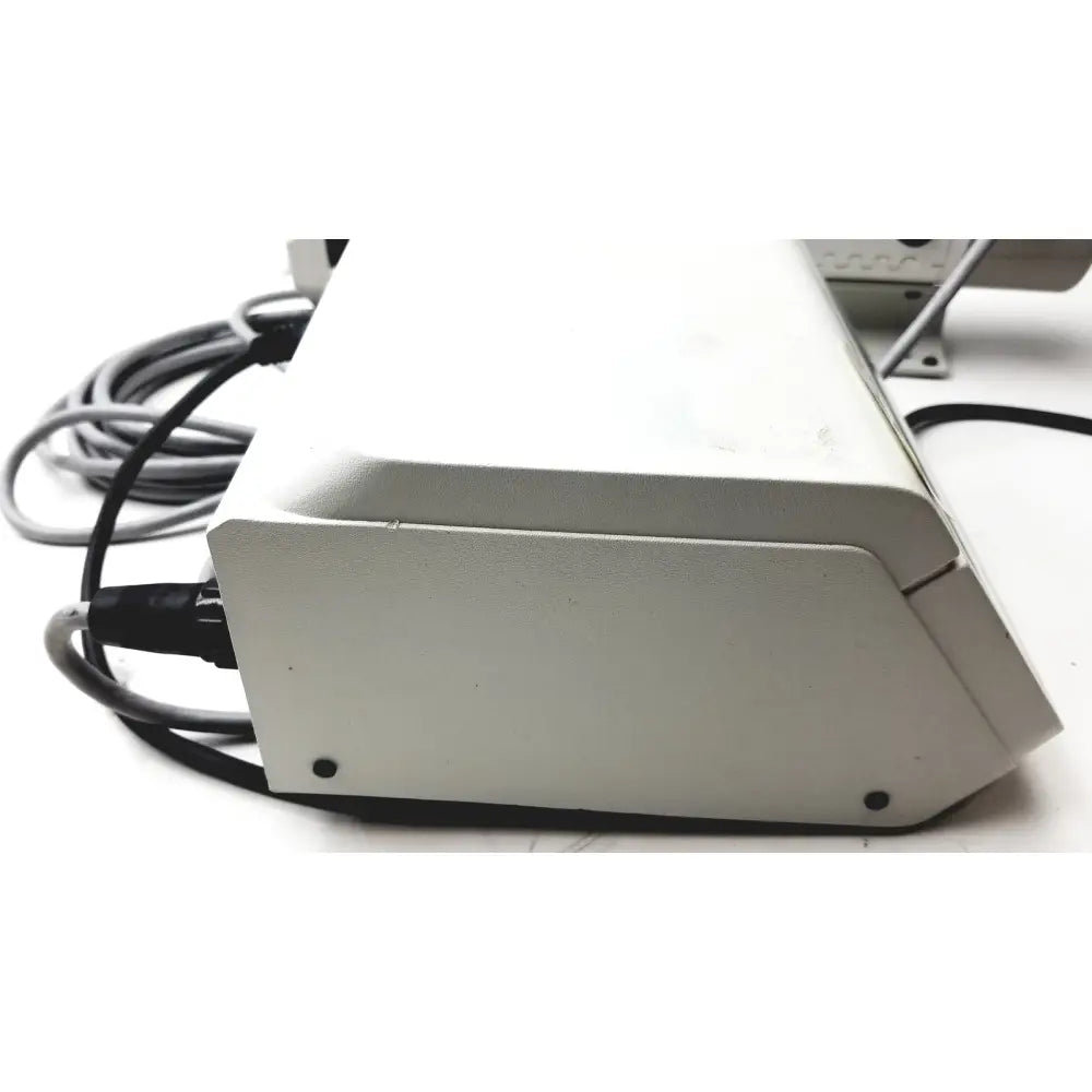White rectangular masterflex digital modular drive with matte finish and cables connected to its side modular drive