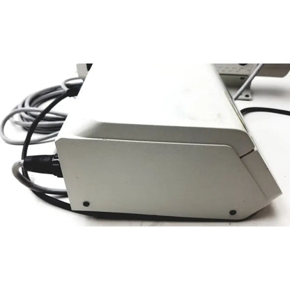White rectangular masterflex digital modular drive with matte finish and cables connected to its side modular drive