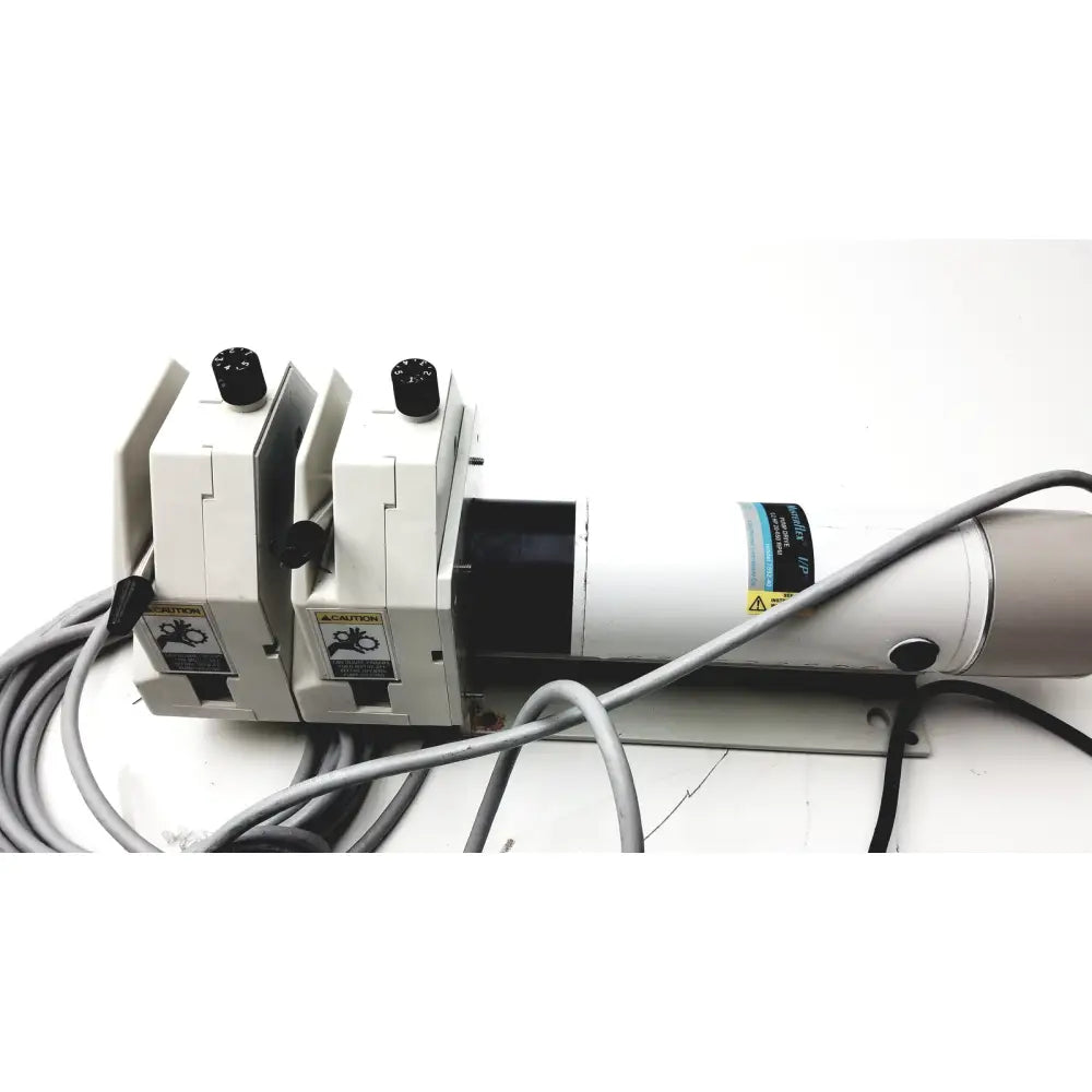 White industrial-grade laser engraving machine with black knobs and warning labels for masterflex digital modular drive