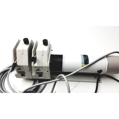 White industrial-grade laser engraving machine with black knobs and warning labels for masterflex digital modular drive
