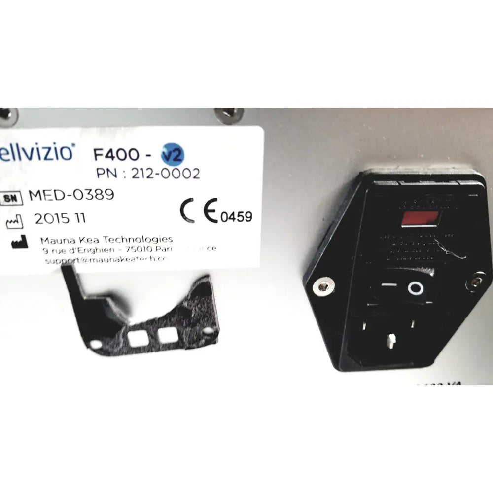 Black plastic power supply unit with red indicator light and metallic screws on the back of mauna kea technologies f400-v2 cellvizio console