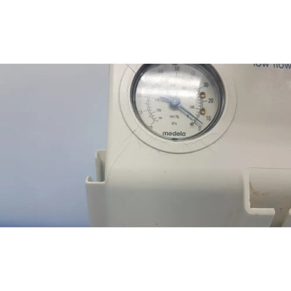 White medela vario suction pump aspirator with circular pressure gauge and blue needle for portable medical use