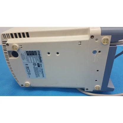 Beige and gray medela vario 18 suction pump aspirator with ventilation slits and technical label on the back side