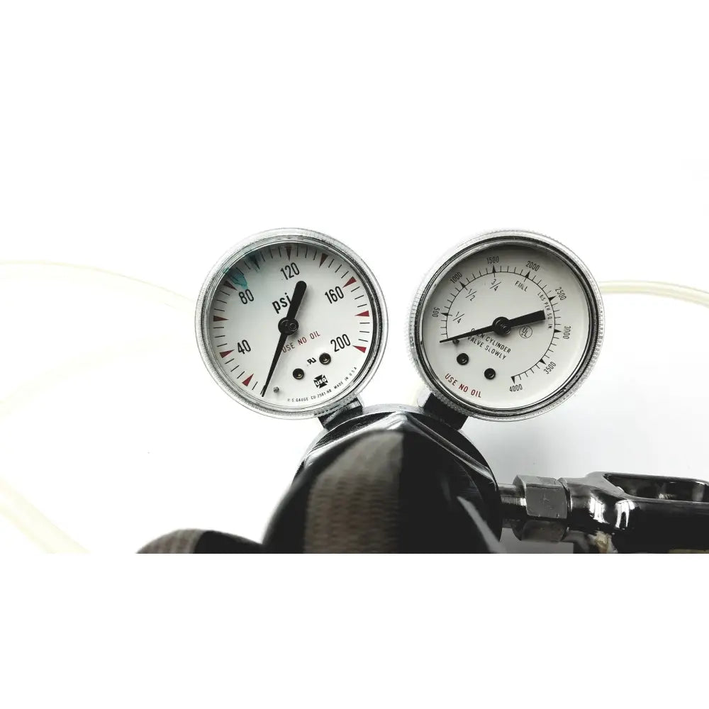 Two circular pressure gauges with white faces on a dark metallic cylinder for medical graphics corp comprressed gas regulator