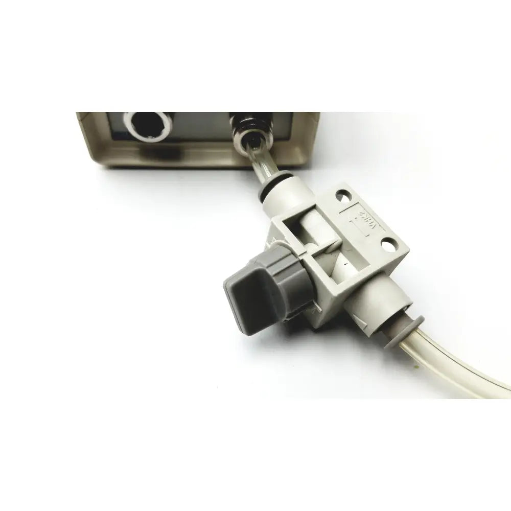 Gray plastic flow control valve with black knob and transparent tubing on medical graphics corp comprressed gas regulator with cosmed calibration unit
