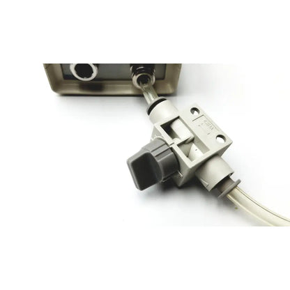 Gray plastic flow control valve with black knob and transparent tubing on medical graphics corp comprressed gas regulator with cosmed calibration unit
