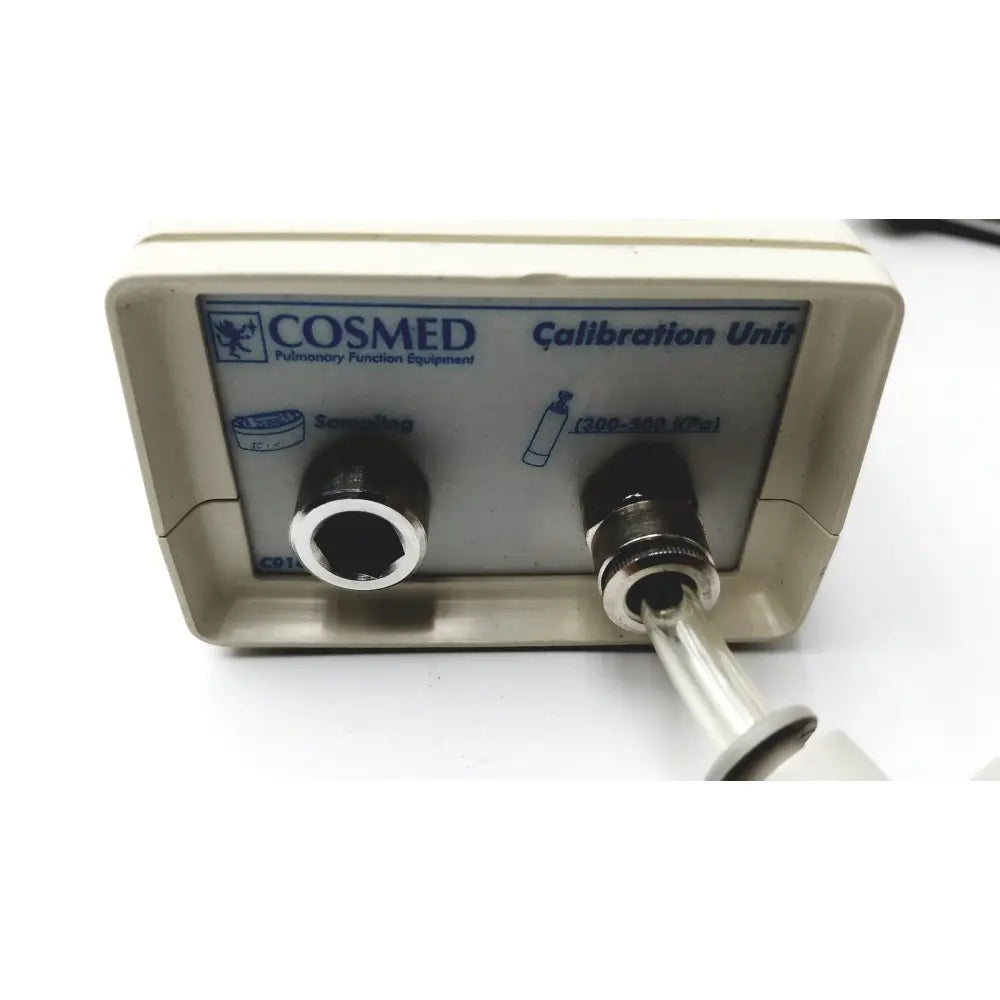 Beige medical graphics corp compressed gas regulator with cosmed calibration unit featuring two black ports and silver tube