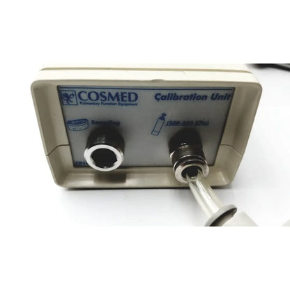 Beige medical graphics corp compressed gas regulator with cosmed calibration unit featuring two black ports and silver tube