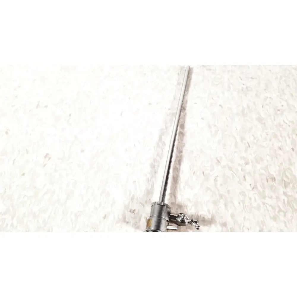 A sleek metallic medical horizon single valve endoscope sheath with a slender shaft and adjustable knob handle
