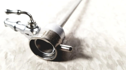 Silver-colored metal medical horizon endoscope with cylindrical body and articulated control handles for single valve use