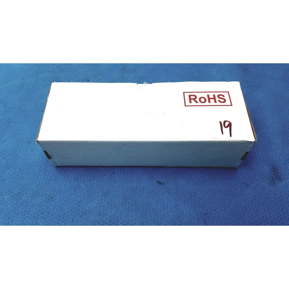 White cardboard box with red rohs stamp and black handwritten 19 for medical power supply covidien kangaroo feeding pump
