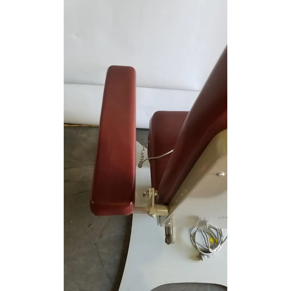 Red upholstered medical power treatment chair model 8678 with metallic frame and adjustable armrests for patient care
