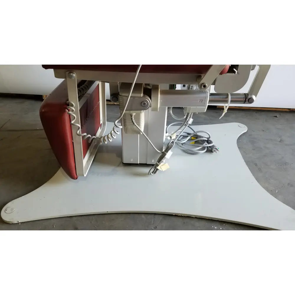 Red and white medical power treatment chair model 8678 with adjustable metal frame and hand control for patient care