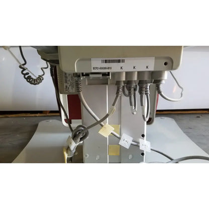 Beige medical power treatment chair model 8678 with hand control and multiple gray cables shown from the back side