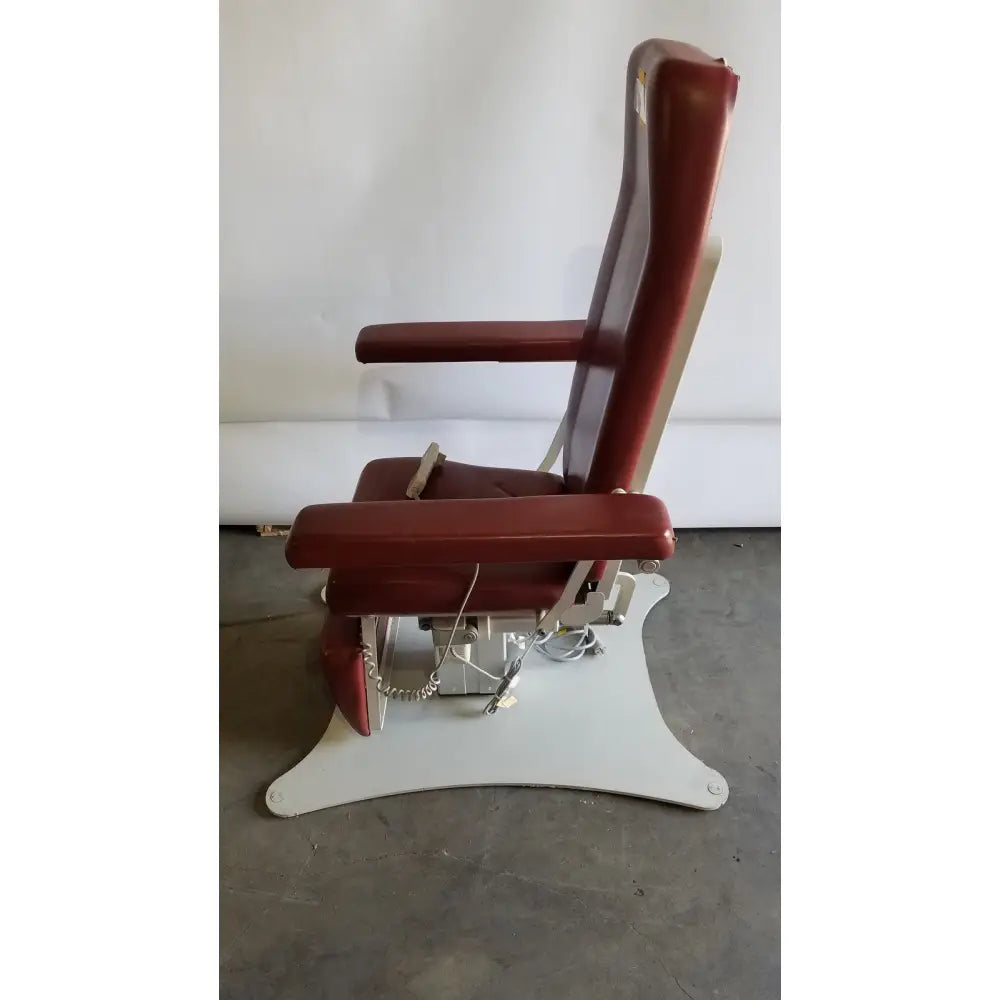 Red leatherette medical power treatment chair model 8678 with white metal base and adjustable armrests hand control