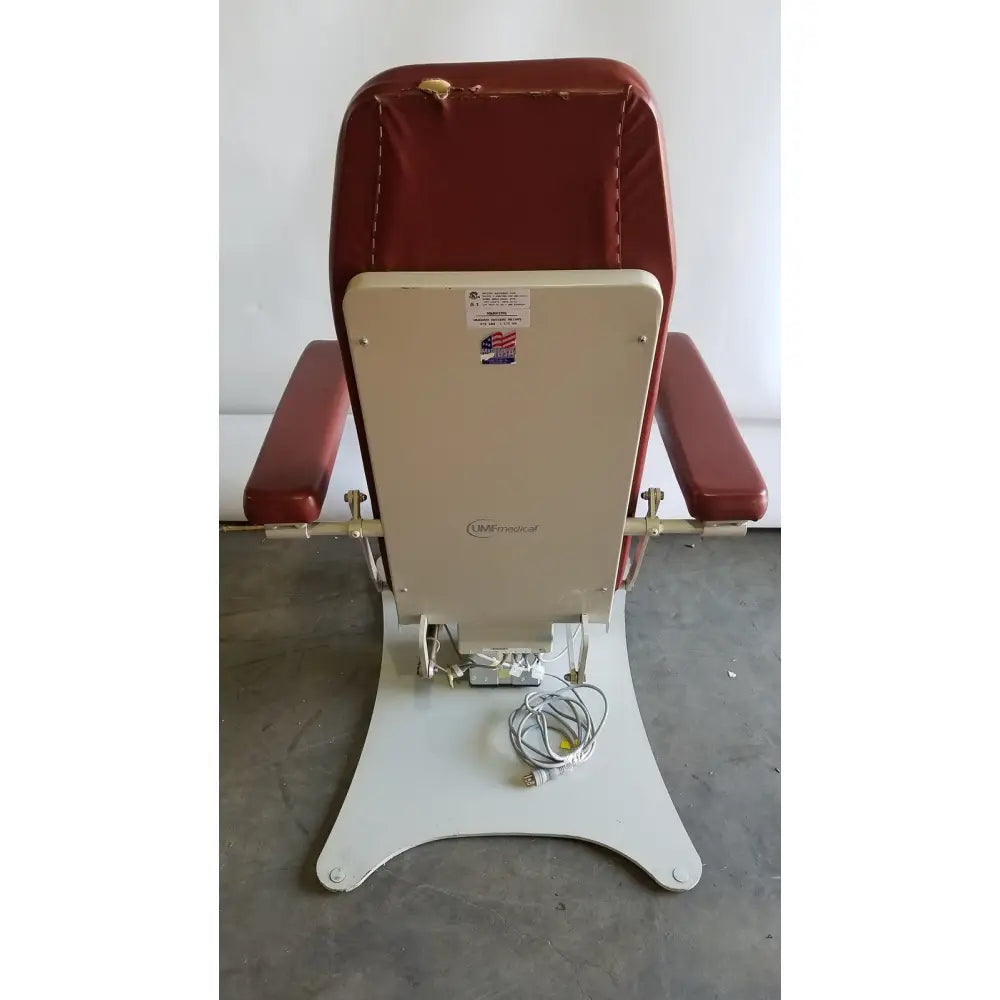 Medical power treatment chair model 8678 with red upholstery, beige back panel, white metal base, and hand control