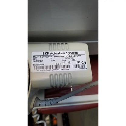 Beige plastic skf actuation system with white label on the back side of a medical power treatment chair model 8678 with hand control