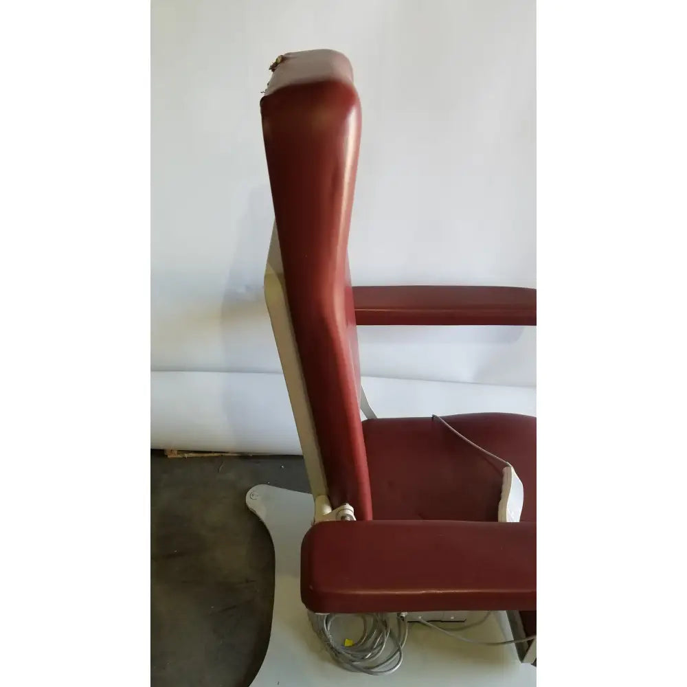 Medical power treatment chair model 8678 with vintage red leather upholstery chrome accents and padded backrest