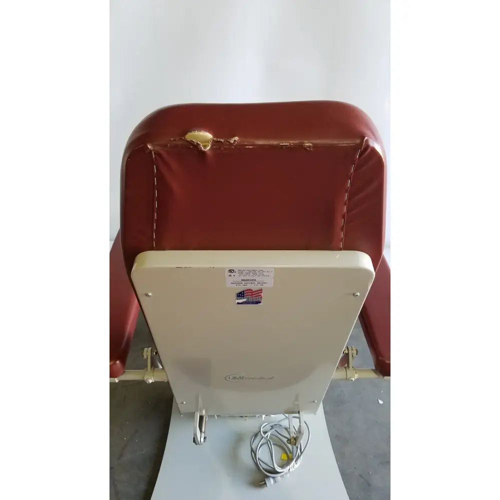Red vinyl-covered medical power treatment chair model 8678 with white metal frame and attached hand control power cord