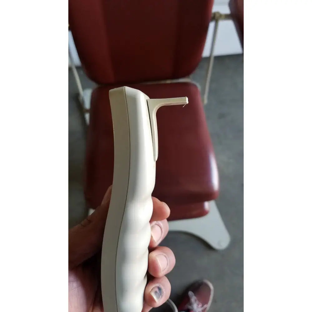 Cream-colored plastic hand control with ergonomic design for medical power treatment chair model 8678