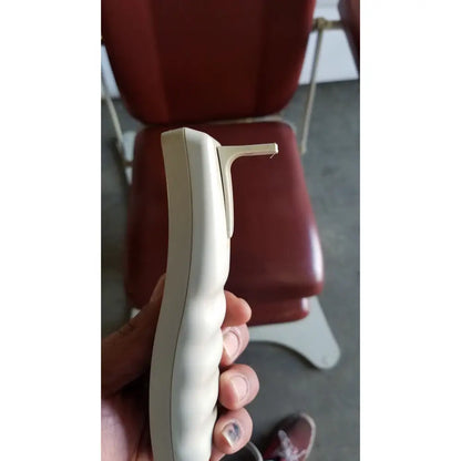 Cream-colored plastic hand control with ergonomic design for medical power treatment chair model 8678