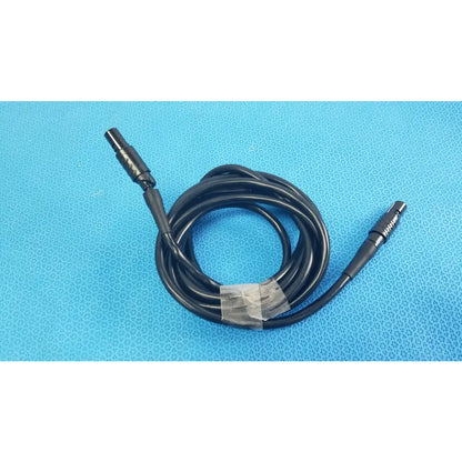 Black coiled medical surgical handpiece console extension cable with two metallic connectors for medical equipment use