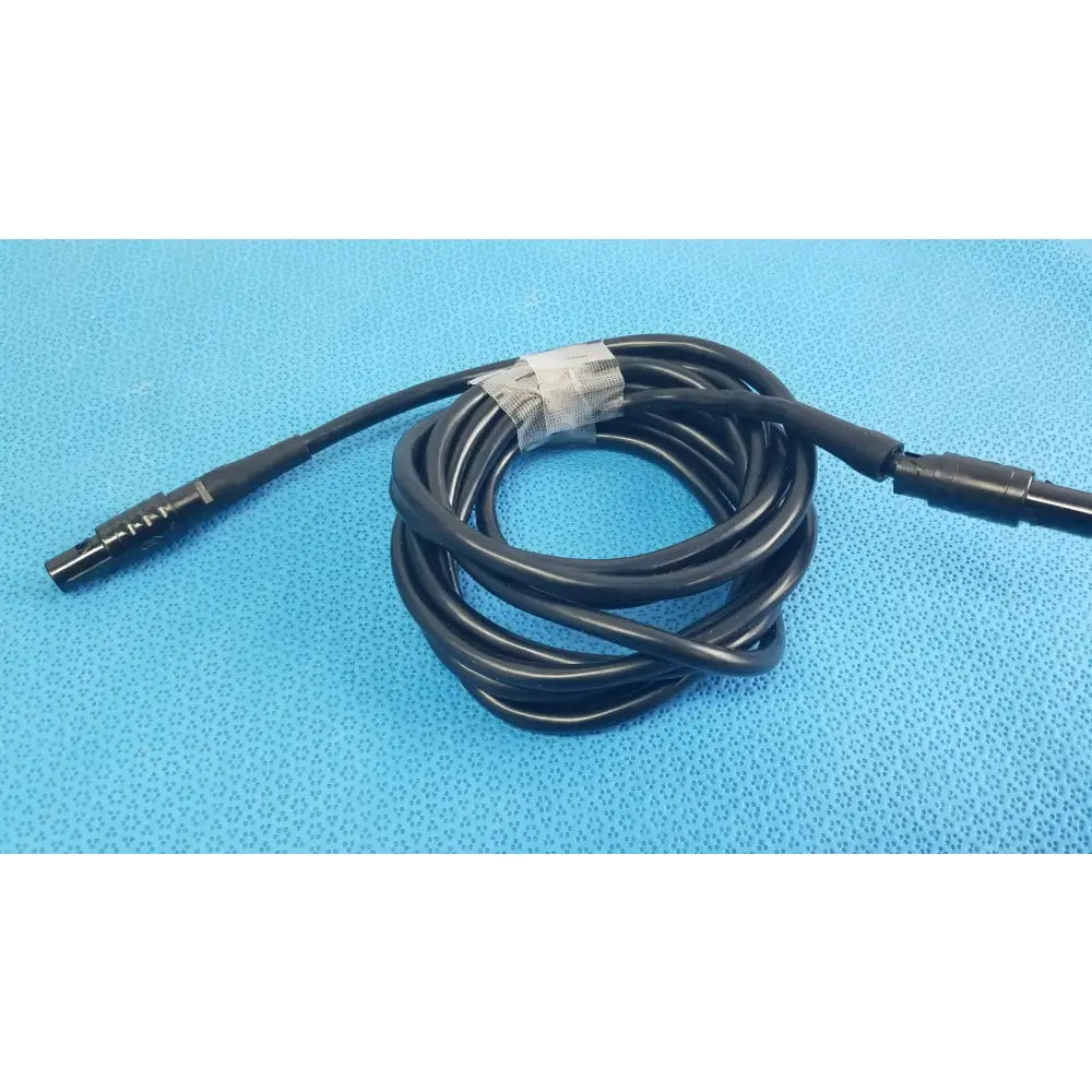 Black coiled medical surgical handpiece console extension cable with threaded metallic and smooth plastic connectors