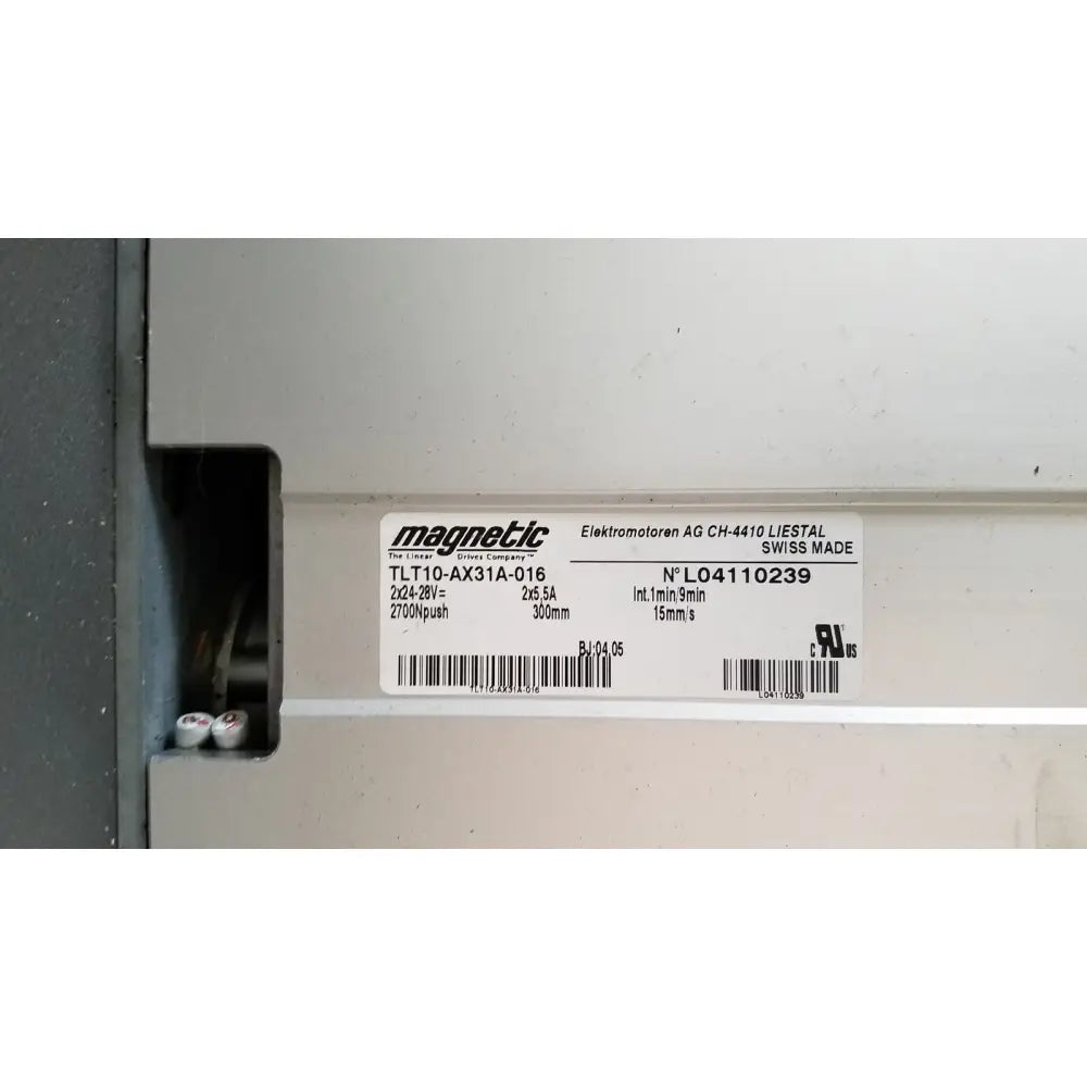White rectangular label with magnetic brand and technical specifications on medical technology industries power lift exam chair
