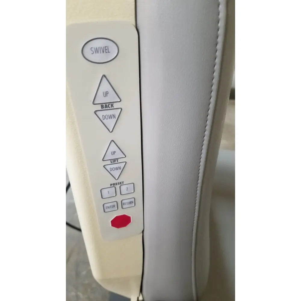 Cream-colored control panel with silver buttons and red power button on medical technology industries power lift exam chair