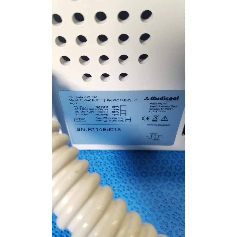 White plastic medicool pro vac file v2 dust vacuum pump with perforated casing and blue label showing specifications