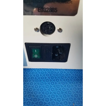 White plastic power panel of medicool pro vac file v2 dust collector with green on off switch and circular connector