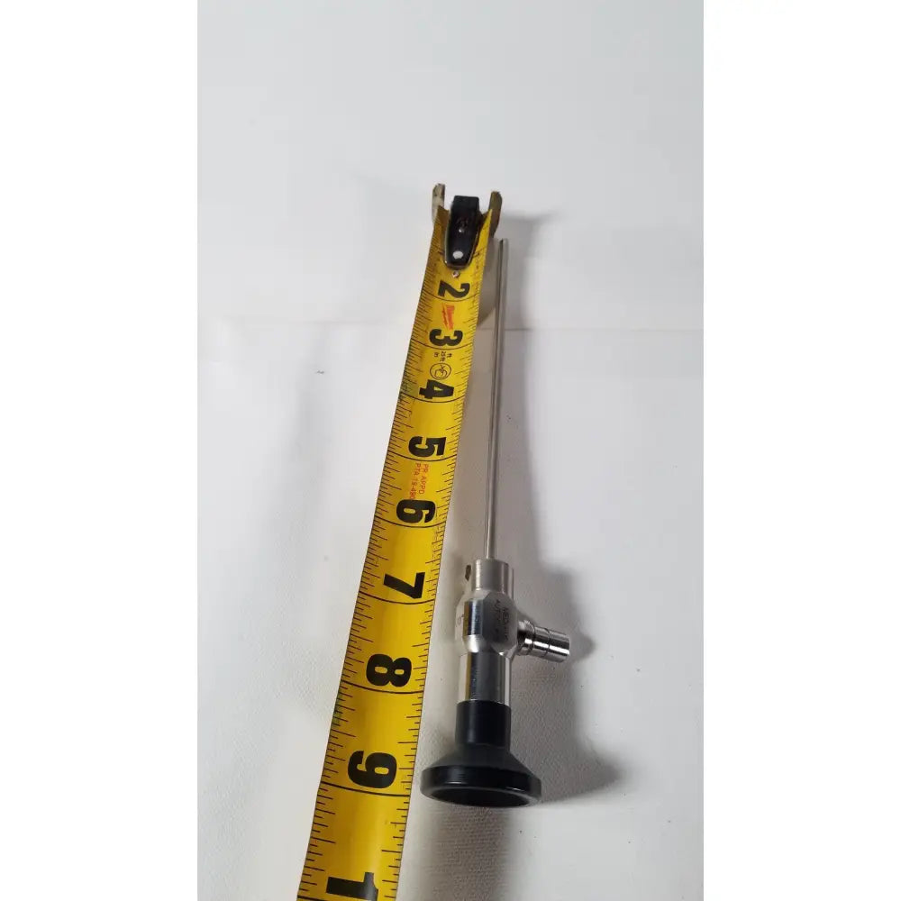 Silver medifix autoclave d-5540 30 degree endoscope with black rubberized handle and yellow measuring tape beside it