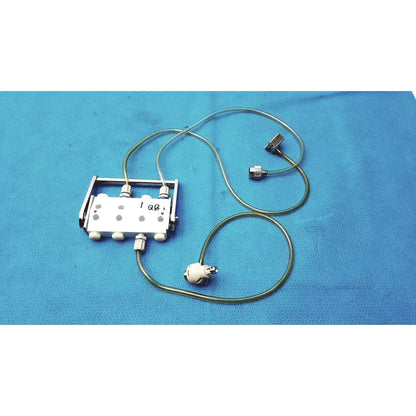 Silver surgical hook-up connector assembly medivators 907315 with multiple ports and green tubing attached to metallic connectors