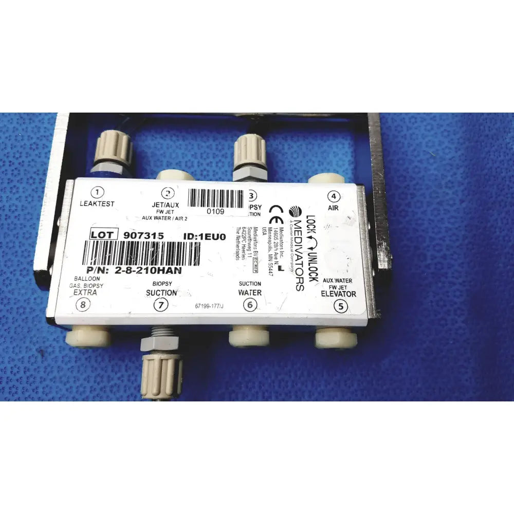 White plastic medivators 907315 hook-up connector assembly with beige threaded ports and black lock & lock mediators labeling