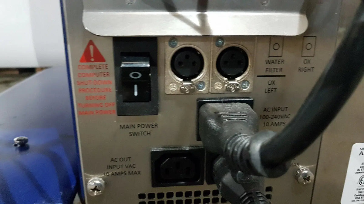 Black power cord plugged into silver industrial electrical panel on the back of medivators advantage plus endoscope reprocessor