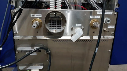 Stainless steel back panel of medivators advantage plus endoscope reprocessor system with labeled water inlet drain and air ports