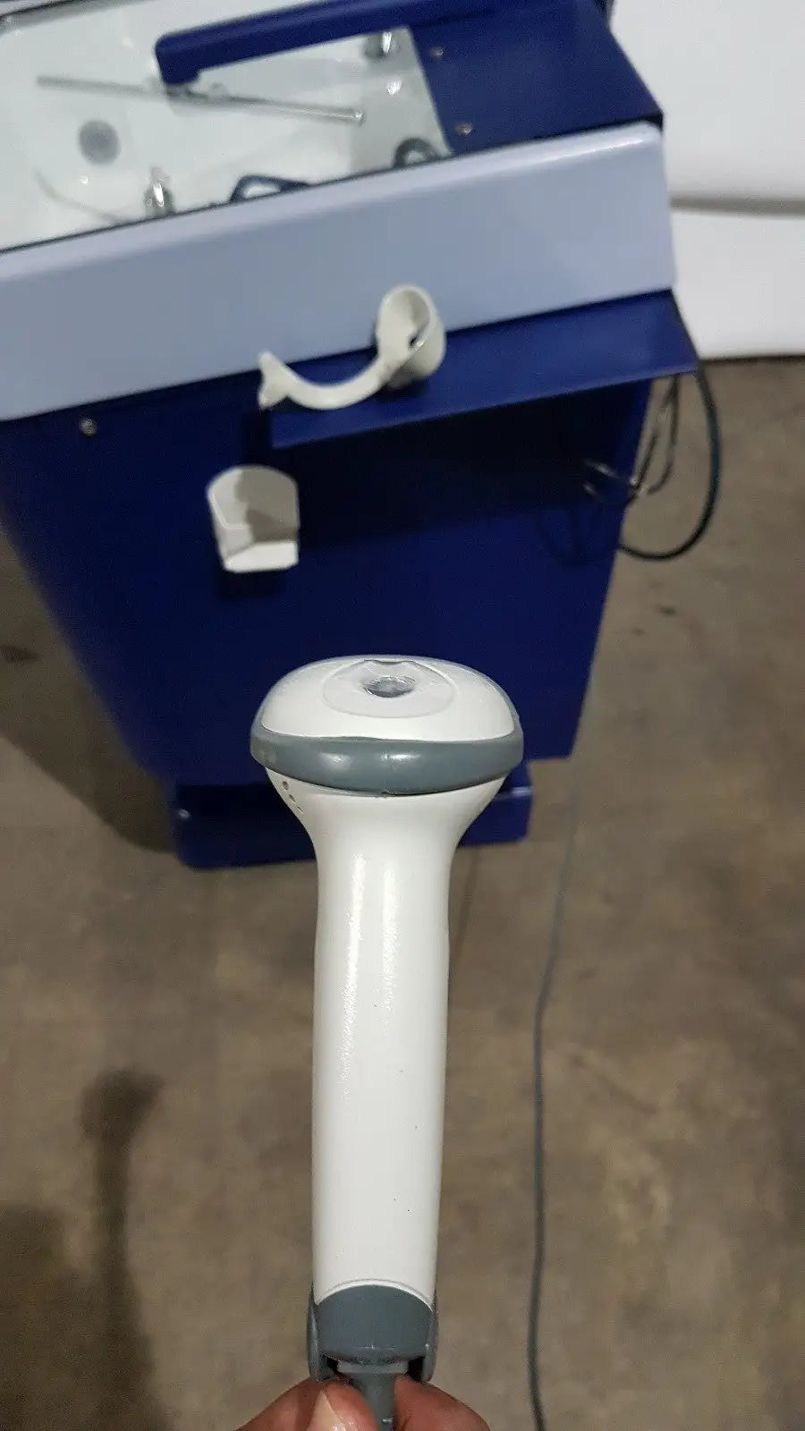 White and gray handheld barcode scanner with ergonomic grip used in medivators advantage plus endoscope reprocessor system