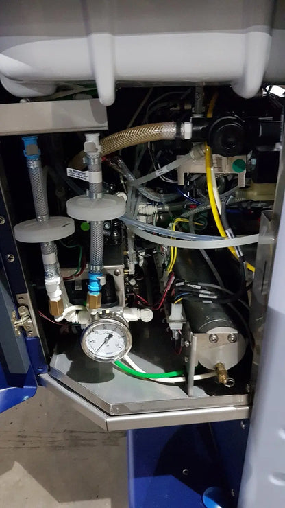 Industrial-grade pressure gauge with white face and black markings on metallic piping in medivators advantage plus endoscope reprocessor