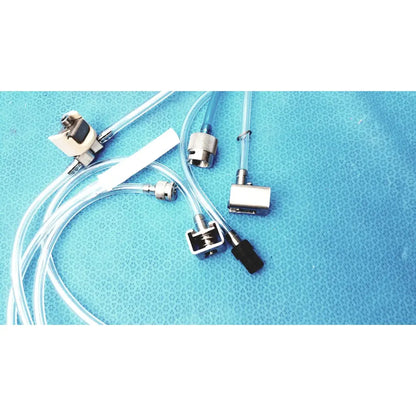 Clear plastic tubing with metallic connectors and black caps on blue surface for medivators hook-up block compatible component