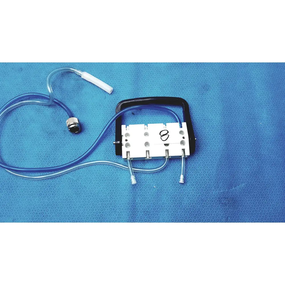 White and black surgical device with blue tubing connected to white cylindrical component medivators hook-up connector assembly 434744