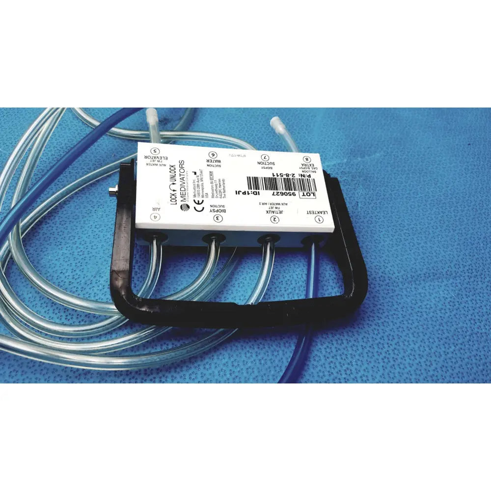 Black plastic medivators hook-up connector assembly 950627 with white label and multiple clear tubing connections