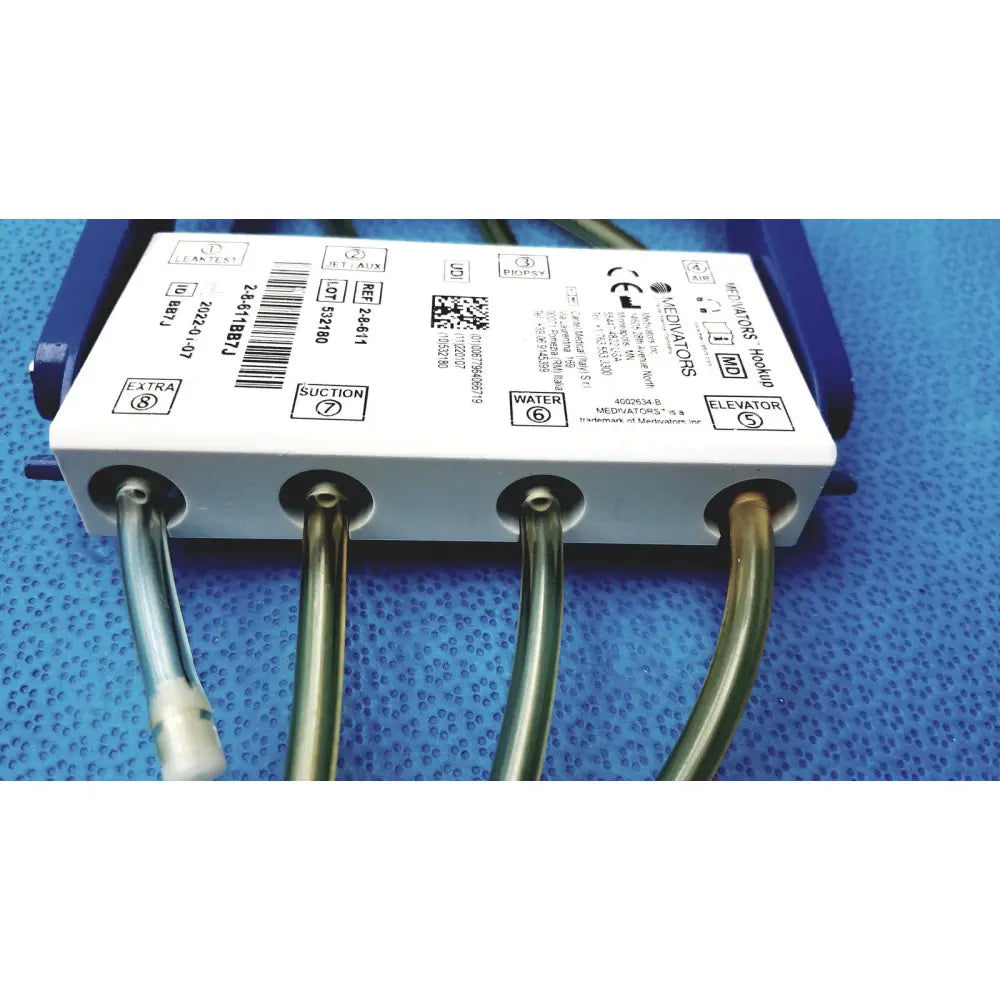White rectangular medivators hook-up connector assembly 950627 with four metallic tubes for suction water elevator and auxiliary functions