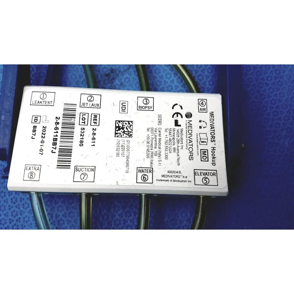 White rectangular Medivators hook-up connector assembly with black printed labels and symbols genuine component