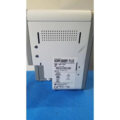 White plastic medivators scope buddy plus endoscope flushing aid with perforated ventilation grille and silver screws back view